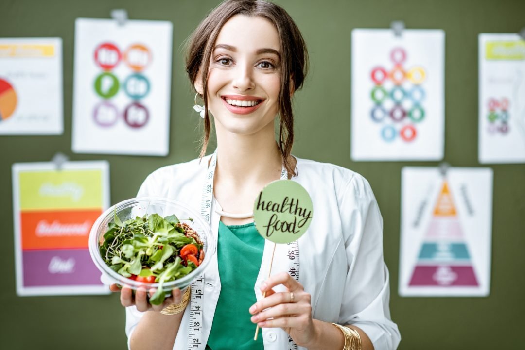 portrait-of-a-woman-dietitian-with-schemes-on-the-topic-of-nutrition.jpg